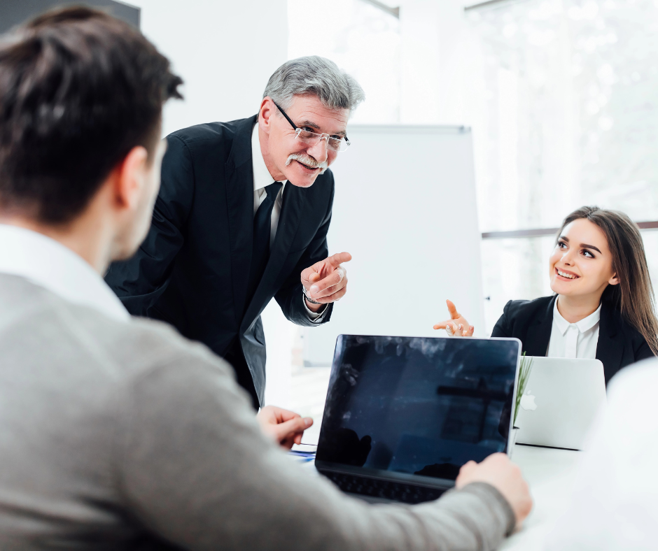 a multi-generational workforce including employees from gen x, gen y, and gen z having a meeting