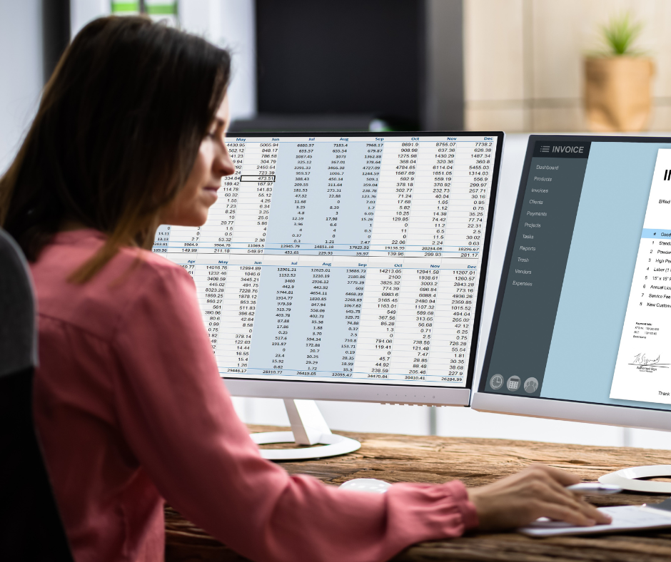 Professional woman working at dual monitors reviewing financial data and invoices, supporting a growing fintech organization by hiring accounting professionals and strengthening financial operations.